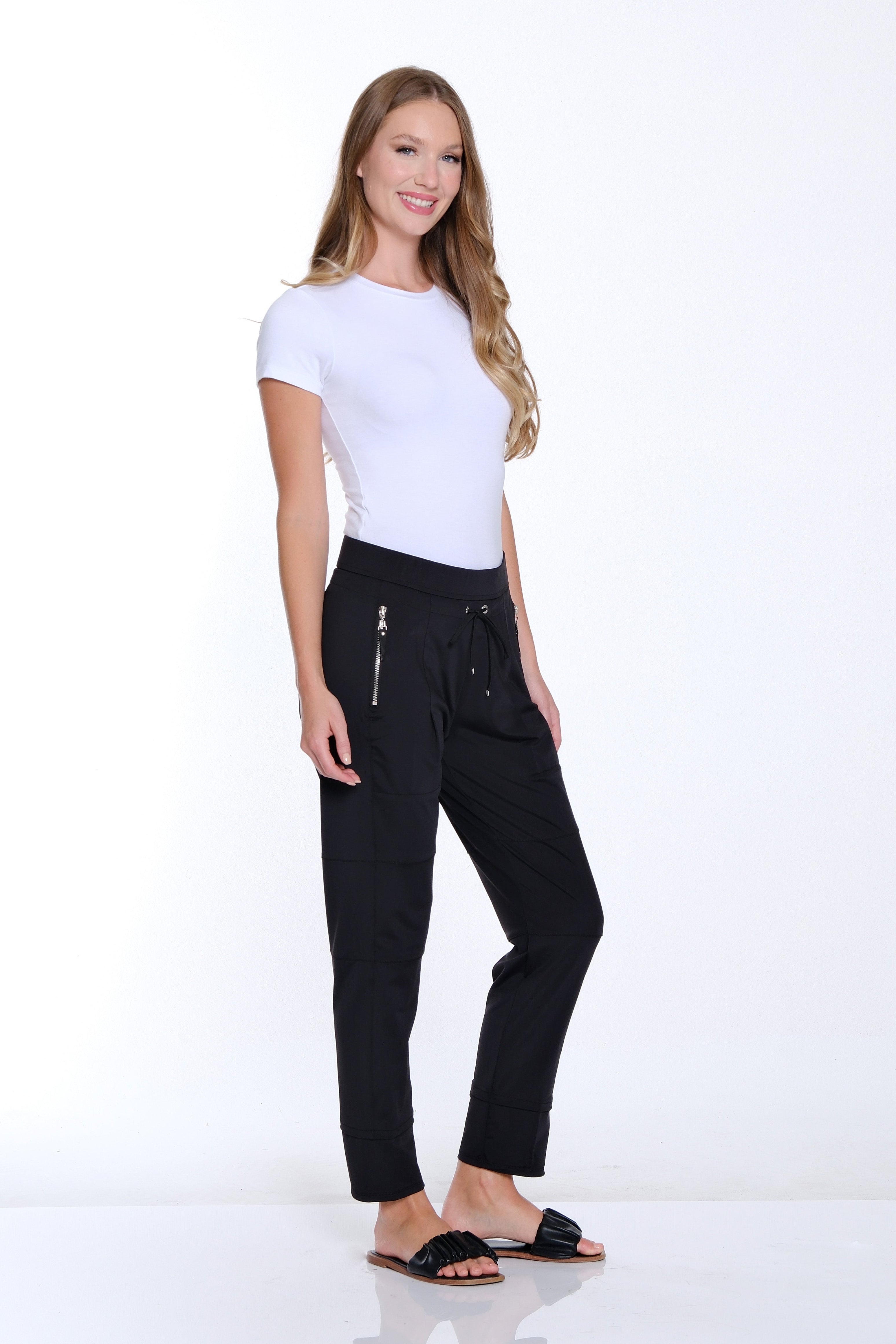 Woman wearing a white t-shirt and black pants on a white background