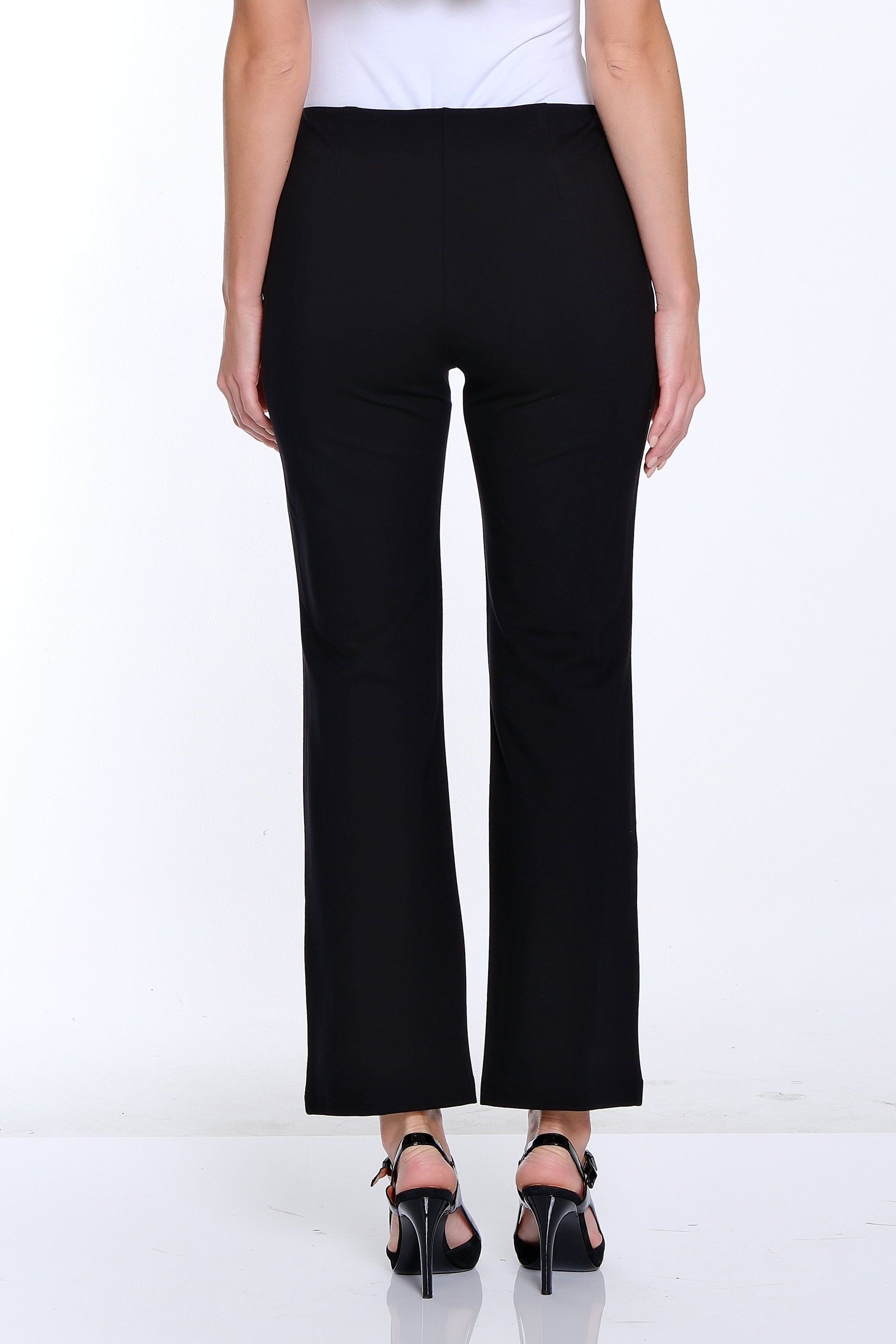 Person wearing a white top and black pants on a white background