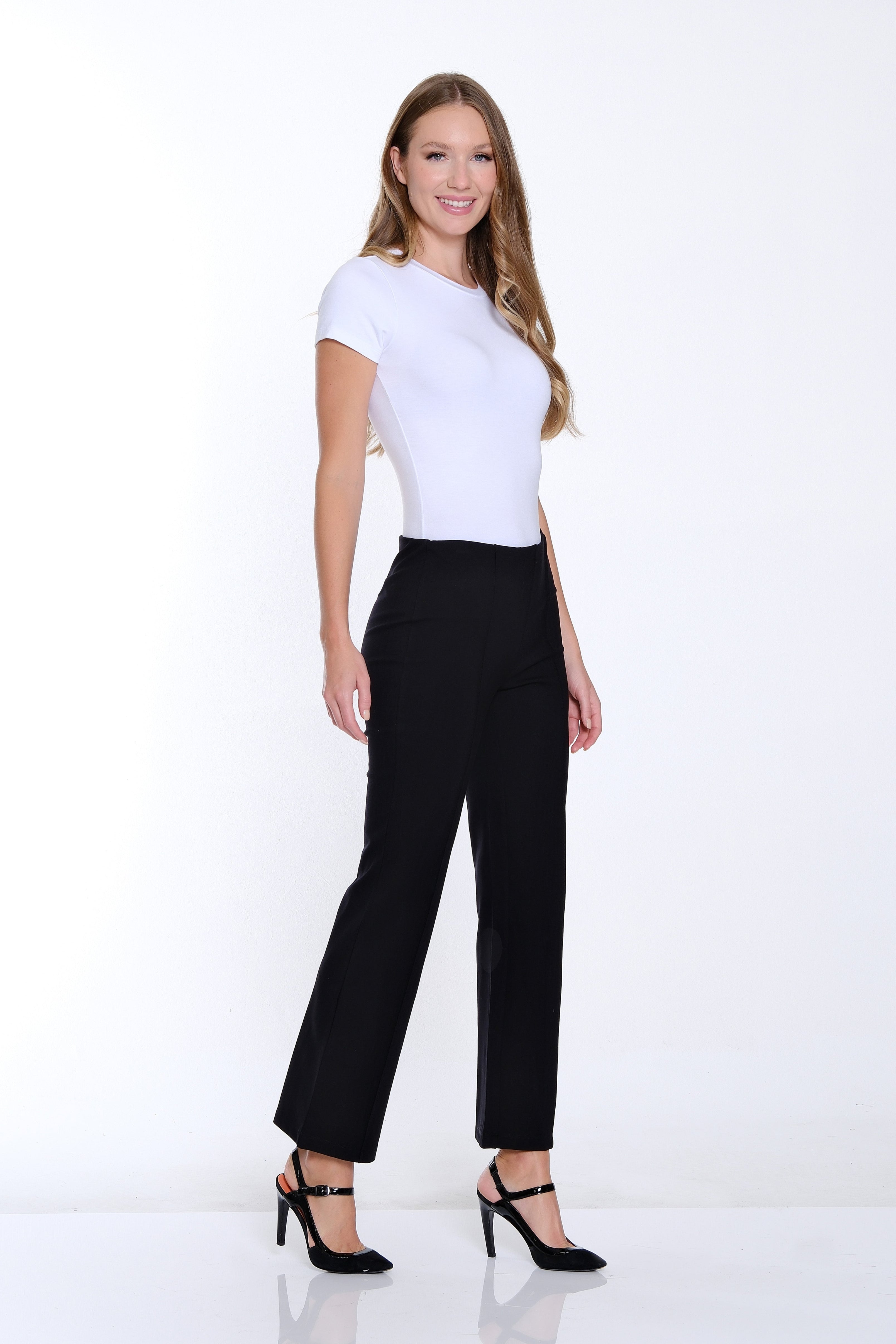Woman wearing a white t-shirt and black pants on a white background