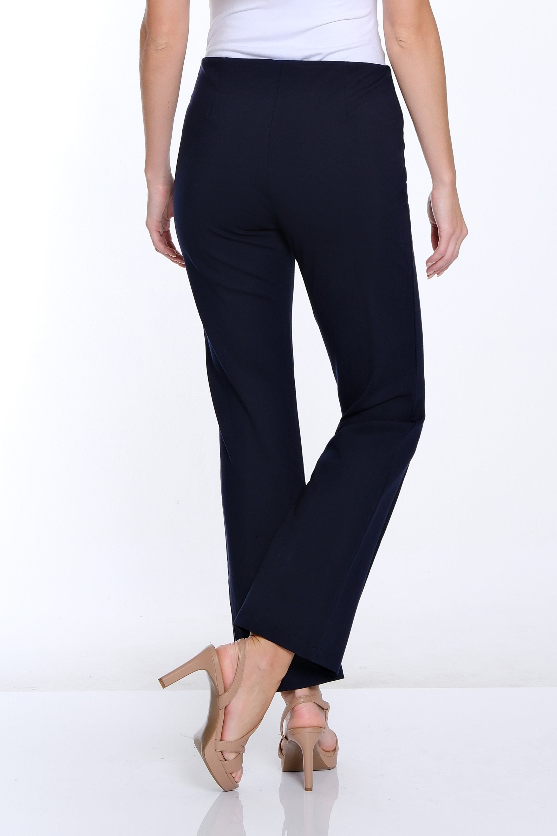 Woman wearing a white t-shirt and black pants on a white background