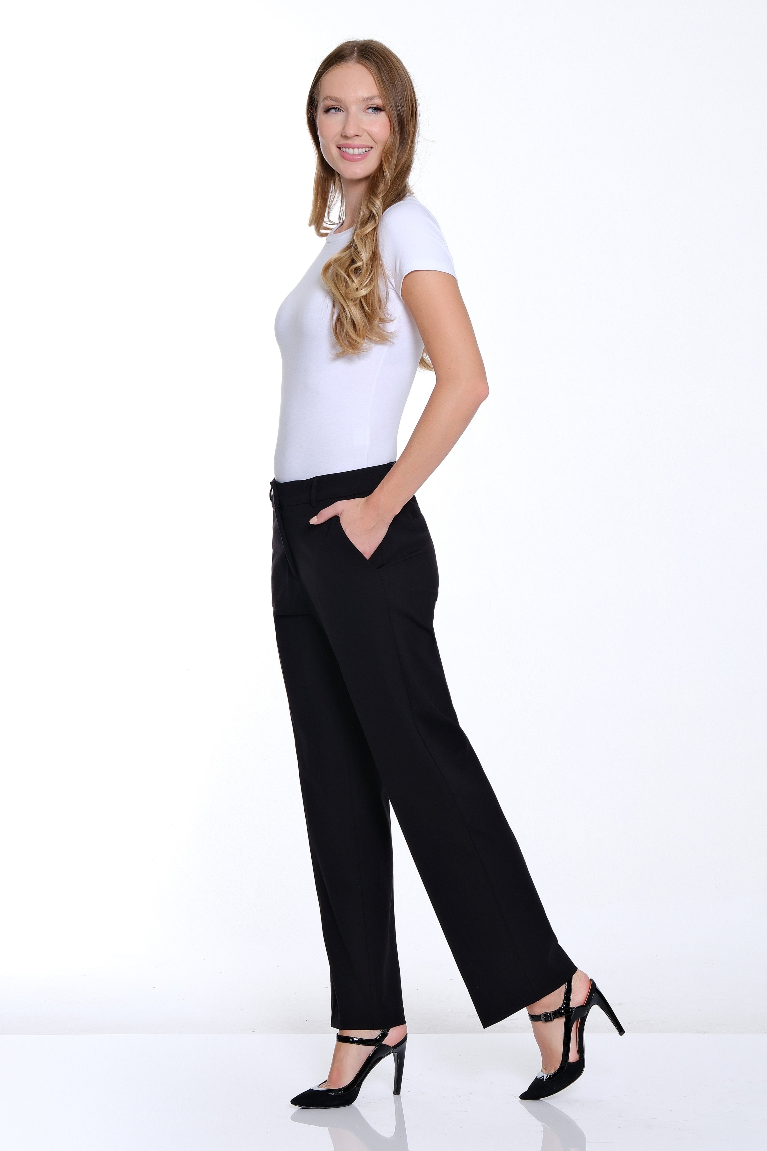 Woman wearing a white t-shirt and black pants on a white background