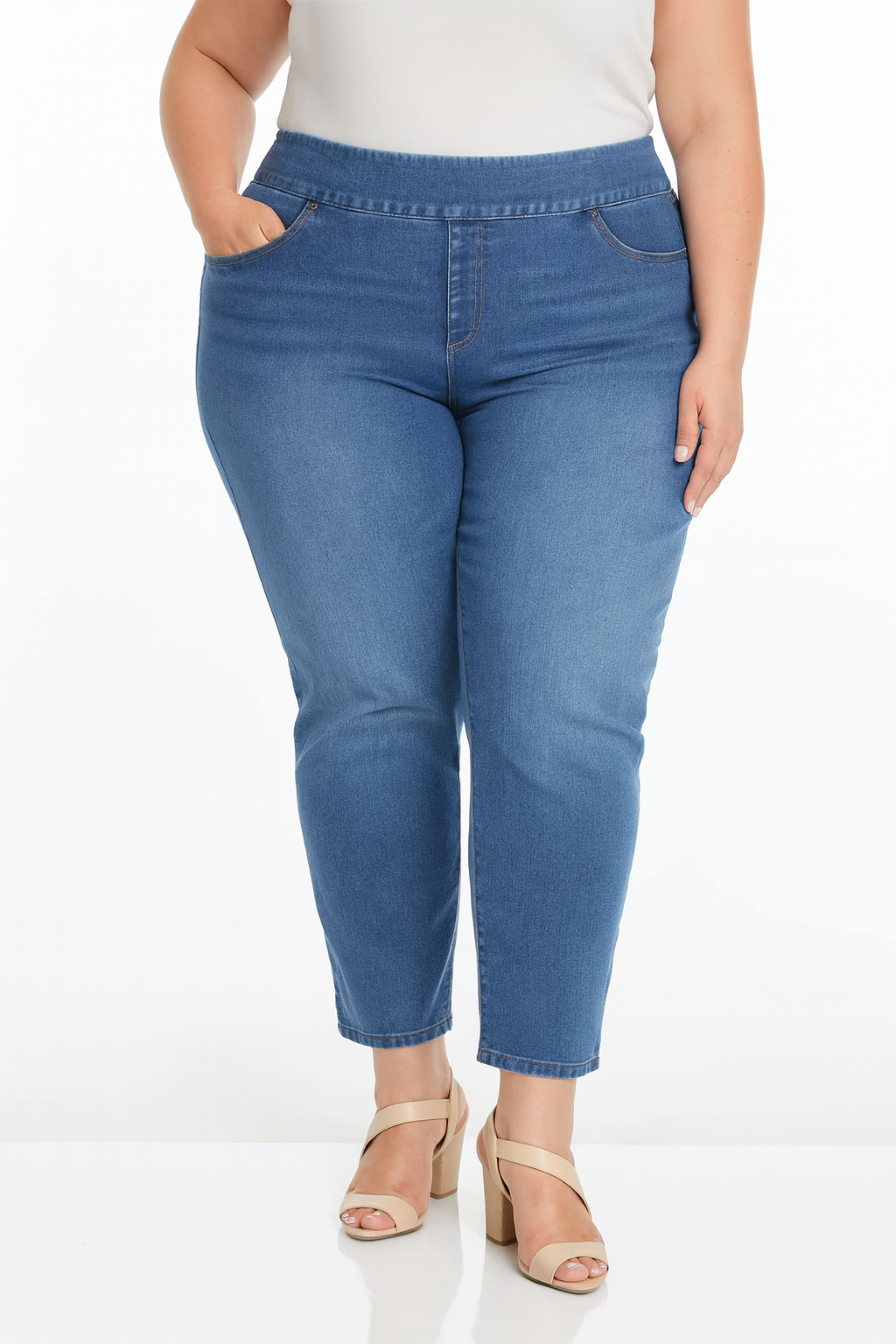 bottom half of plus-size model wearing pull-on straight leg jeans with a wide waistband and high heel sandals