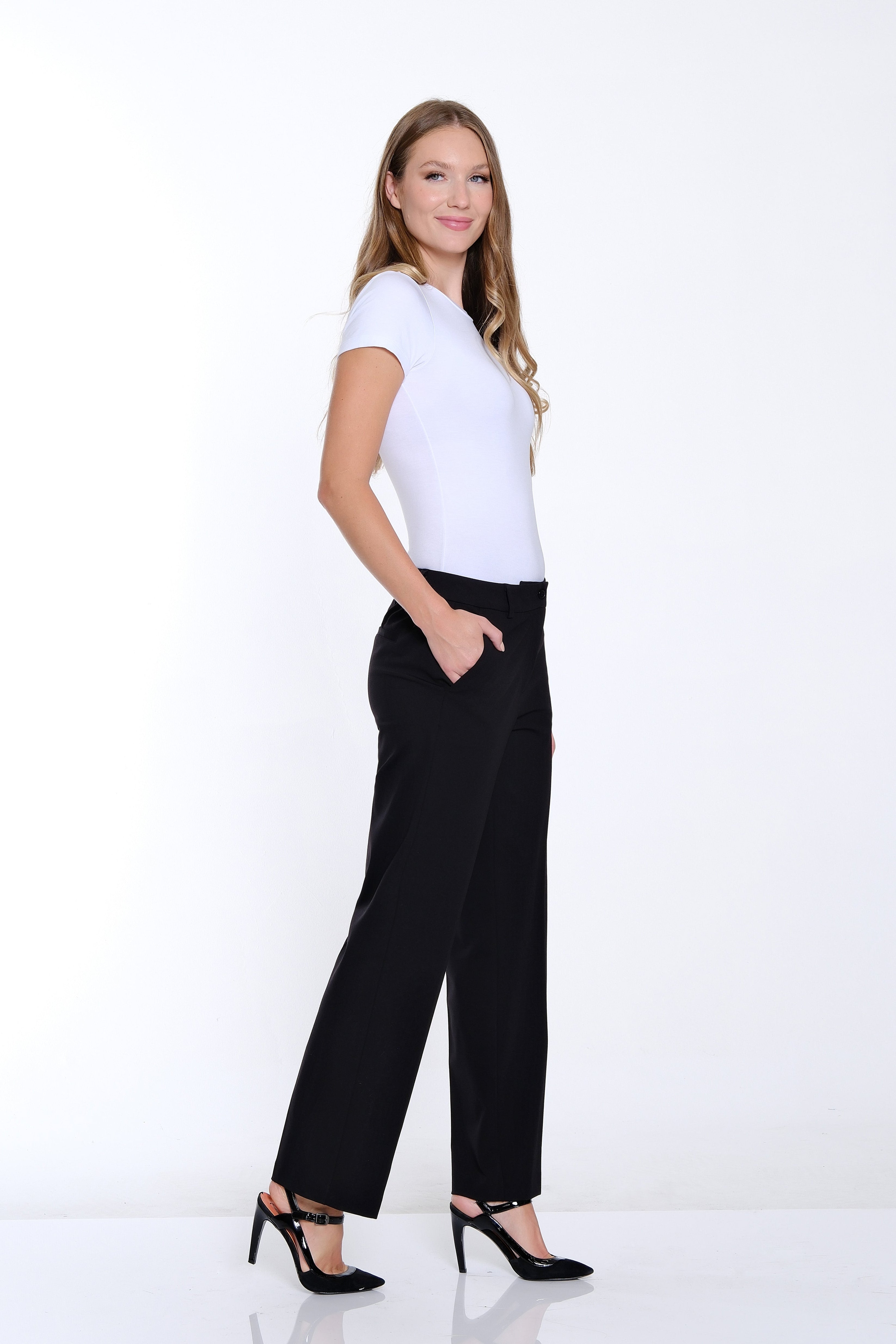 Woman wearing a white t-shirt and black pants on a white background