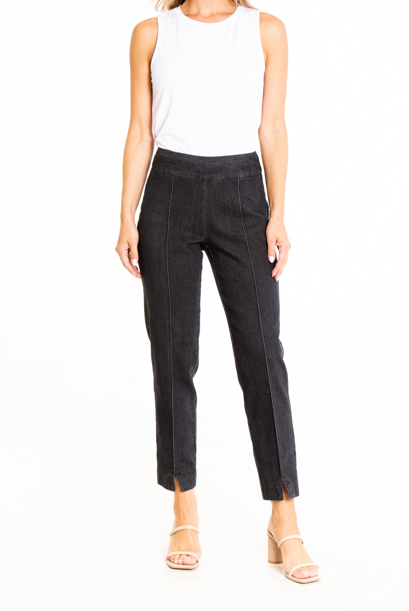 model from neck down wearing white sleeveless blouse and black denim pull-on ankle jeans with high heel sandals